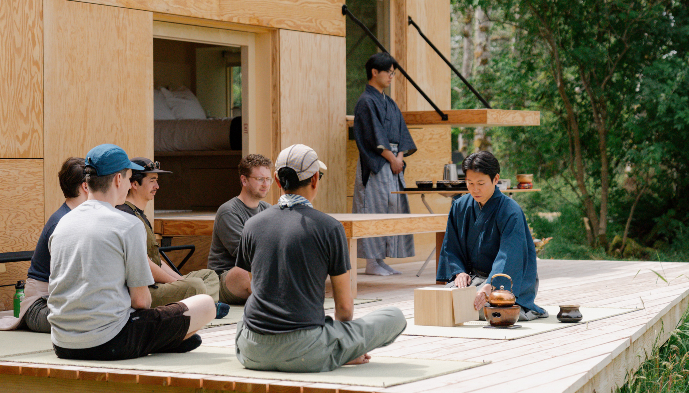 Nodate — an open-air tea ceremony on the deck of a Snow Peak cabin